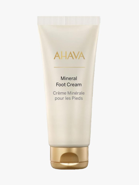 Ahava Dead Sea Water Mineral Foot Cream beige tube with gold cap on light gray background